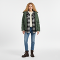 Green hooded padded jacket worn open over a checked overshirt, front view